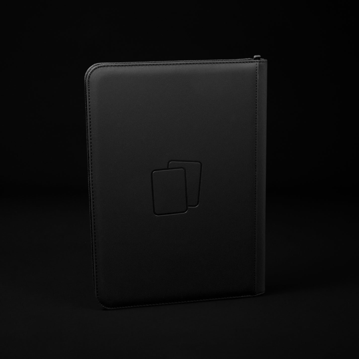Back view of black COVRD card album standing upright showing the debossed logo asset.